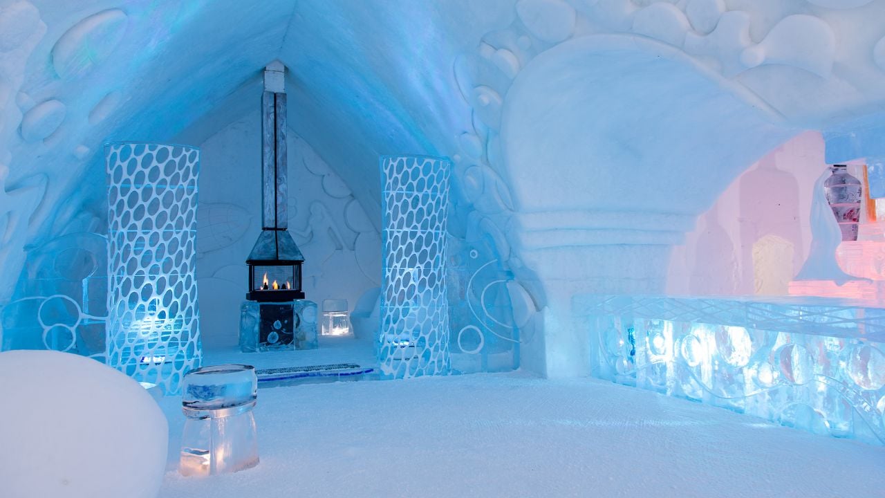 St-Gabriel-de-Valcartier, Quebec, Canada, February 23, 2021 - Lighted fireplace in the world-renowned seasonal Ice Hotel’s spectacular bar illuminated in blue