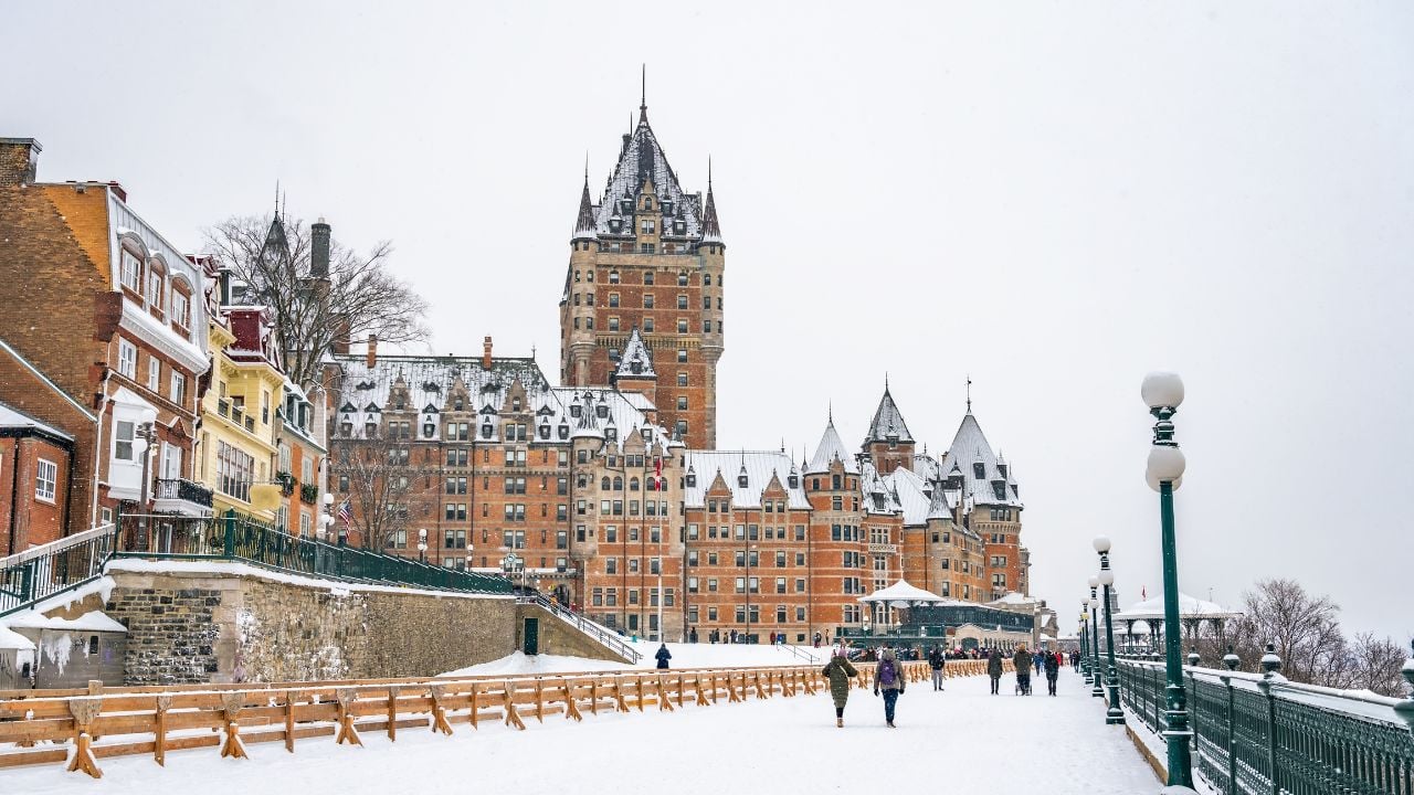 Dufferin Terrace, a long wooden sidewalk next to the historic Fairmont Chateau Frontenac hotel, giant tobogganing run in the winter on a snowy day, Quebec City, Canada. Photo taken in December 2022.