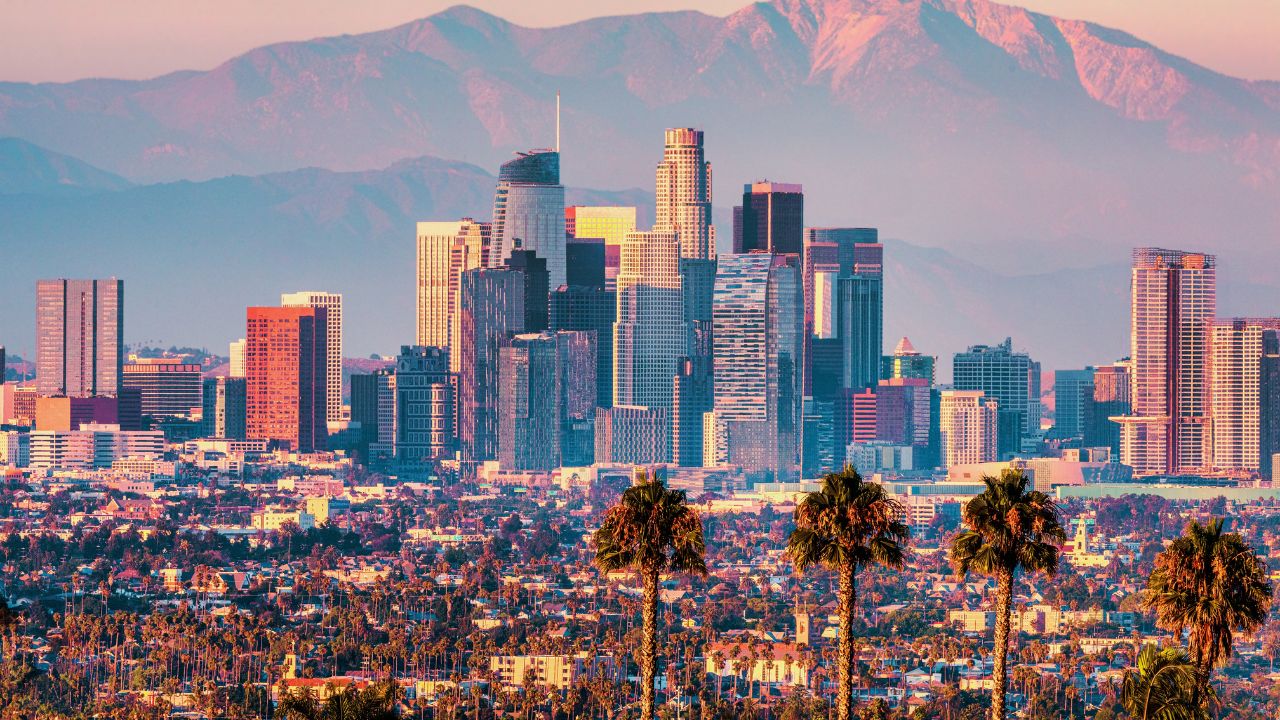 Downtown Los Angeles at sunset. Beautiful view of the city with the San Gabriel Mountains in the background. Concept, Hollywood, Tourism, Cinema, Stars, Celebrities