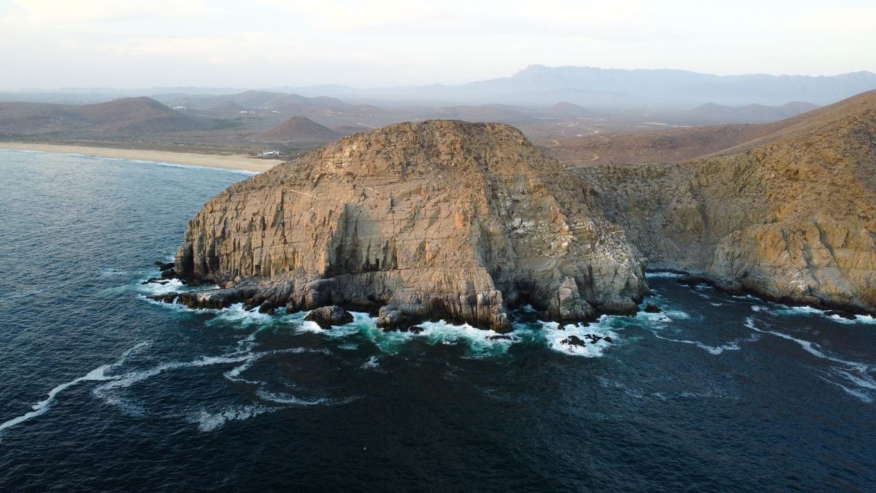 Dramatic cliffs and ocean waves at Punta Lobos, Baja California.