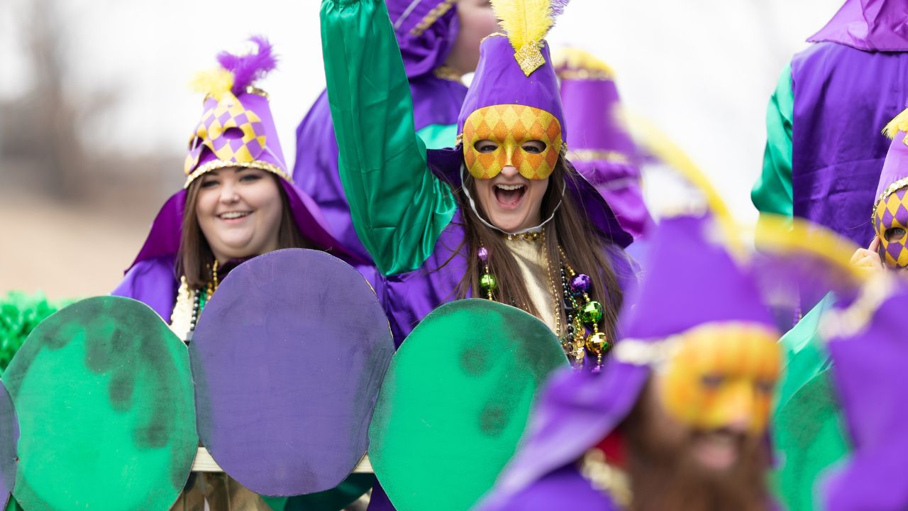 St. Louis, Missouri, USA - Bud Light Grand Parade, Women wearing face masks, and colorful outfits, throwing beads to spectators.