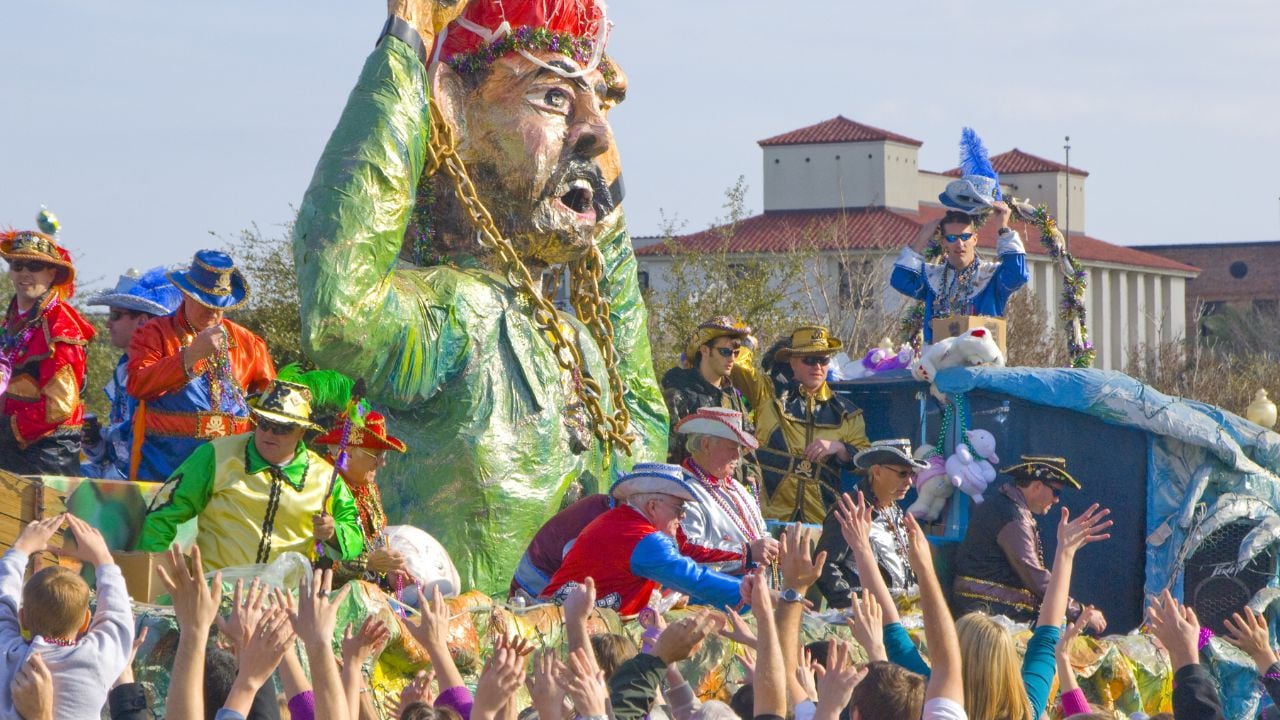 PENSACOLA, FLORIDA - FEBRUARY 13: Revelers beg for beads at the Grand Mardi Gras parade in Pensacola, Florida on February 13, 2010. Mardi Gras is a huge tourism draw celebrated here since 1874.