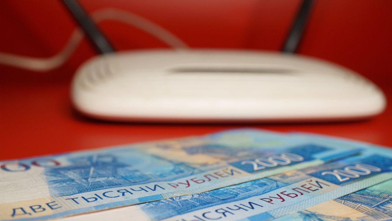 Paper bills on the background of a WiFi router. Russian rubles