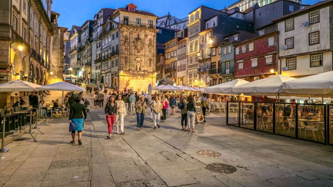 Porto, Portugal - 7 June, 2025: People walking at the Ribeira neighborhood. Ribeira's narrow cobblestone streets are dotted with small bars and restaurants serving classic Portuguese cuisine.