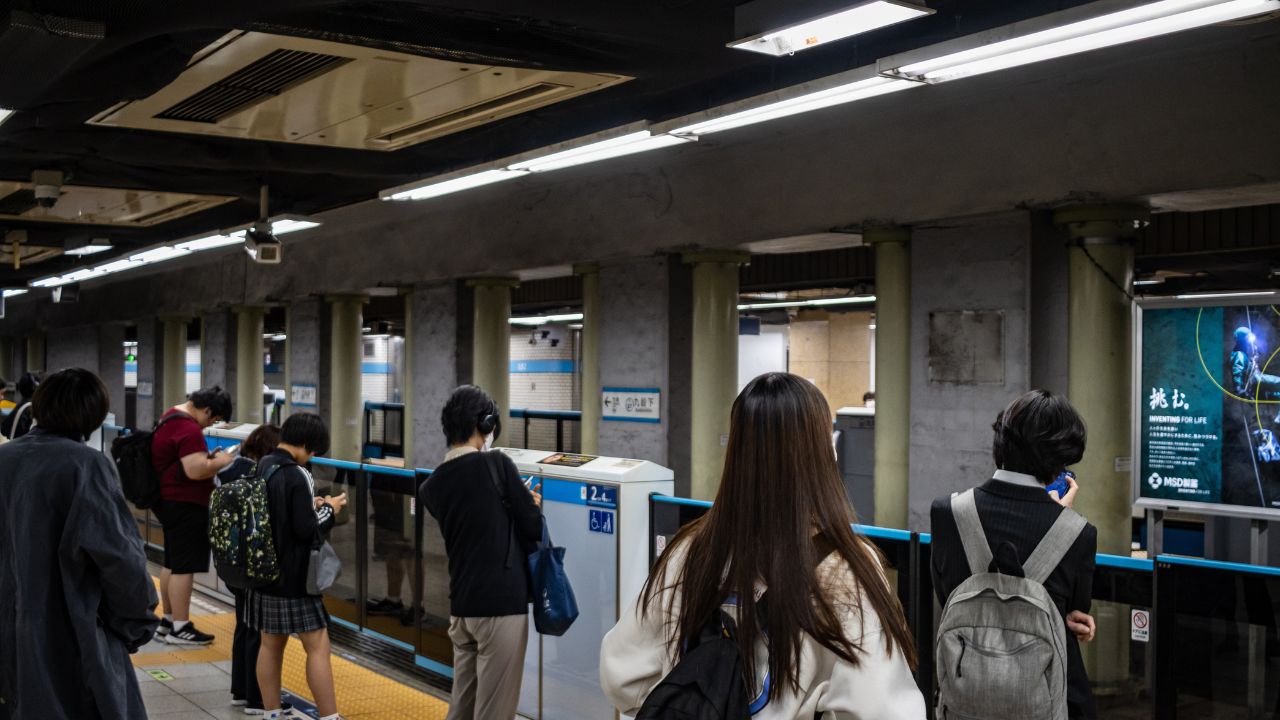 Tokyo, Japan, 26 October 2023: Passengers in line at a subway platform waiting to board the train