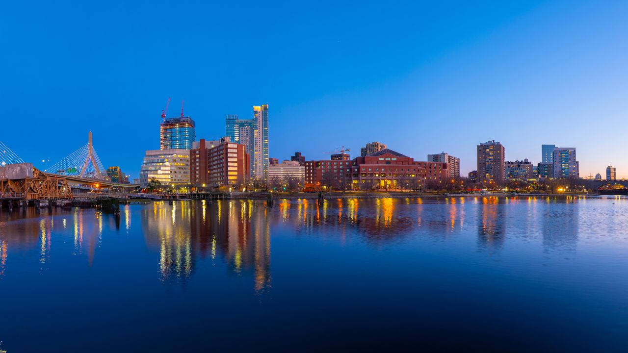 Boston Leonard P. Zakim Bunker Hill Memorial Bridge and Charles River panorama at night with twilight, Boston, Massachusetts MA, USA.