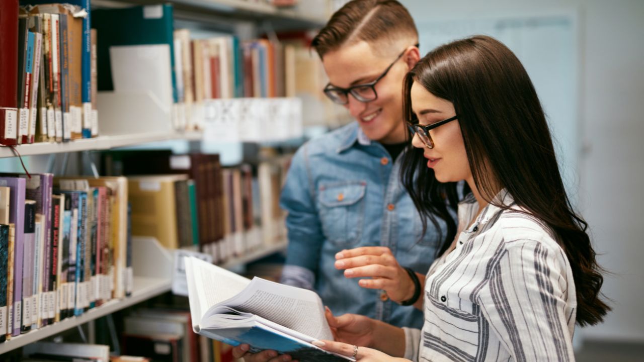 Couple Of Students In College Library