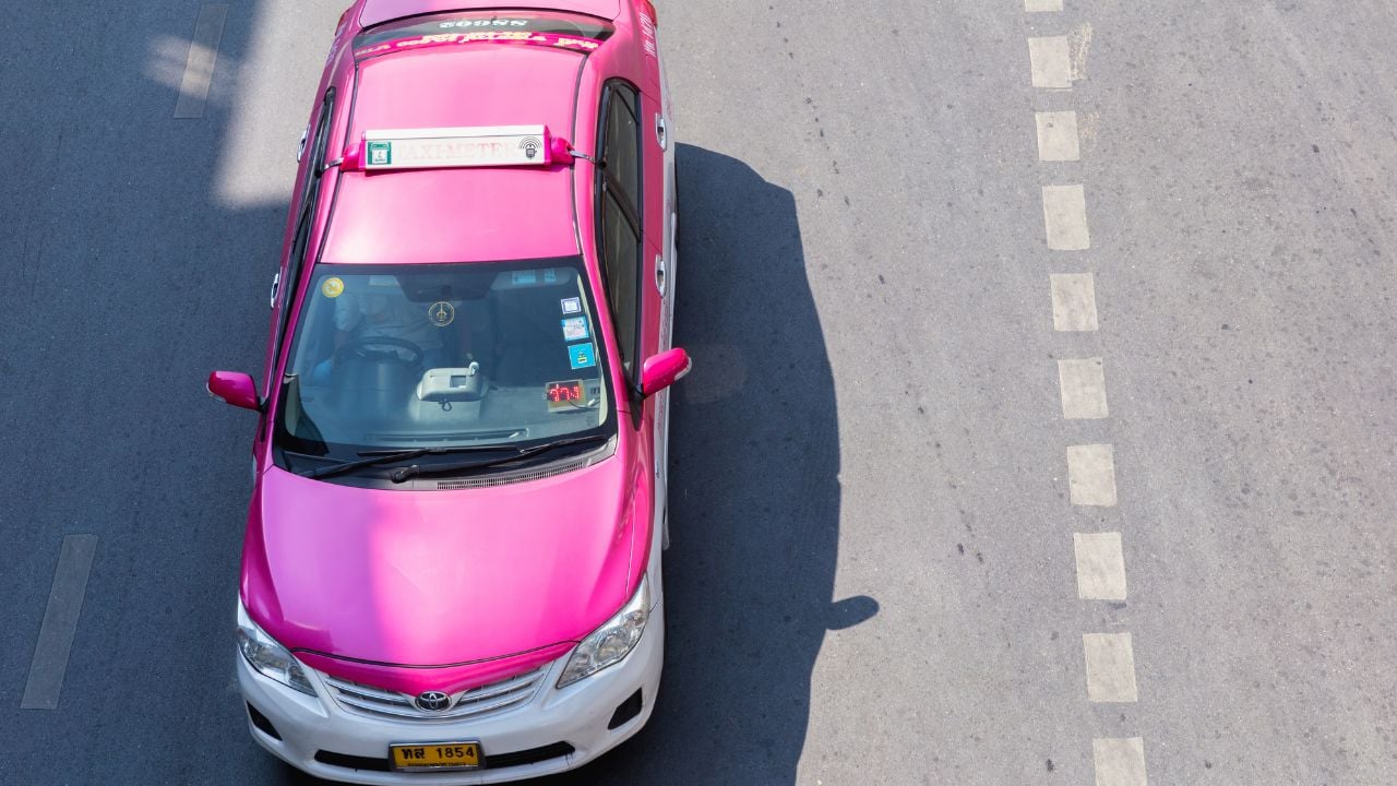 BANGKOK, THAILAND - JAN 10: Colorful Bangkok taxis on the street on January 10, 2016 in Bangkok. Public transport develops rapidly in Bangkok, however traffic congestion is still a problem.