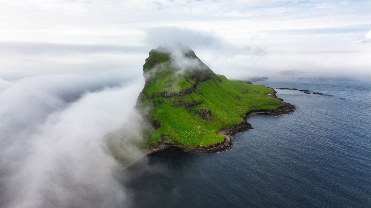 Faroe Islands Vagar, aerial drone view of Tindholmur island during sunset in North Atlantic Ocean. Faroe Islands, Denmark, Europe.