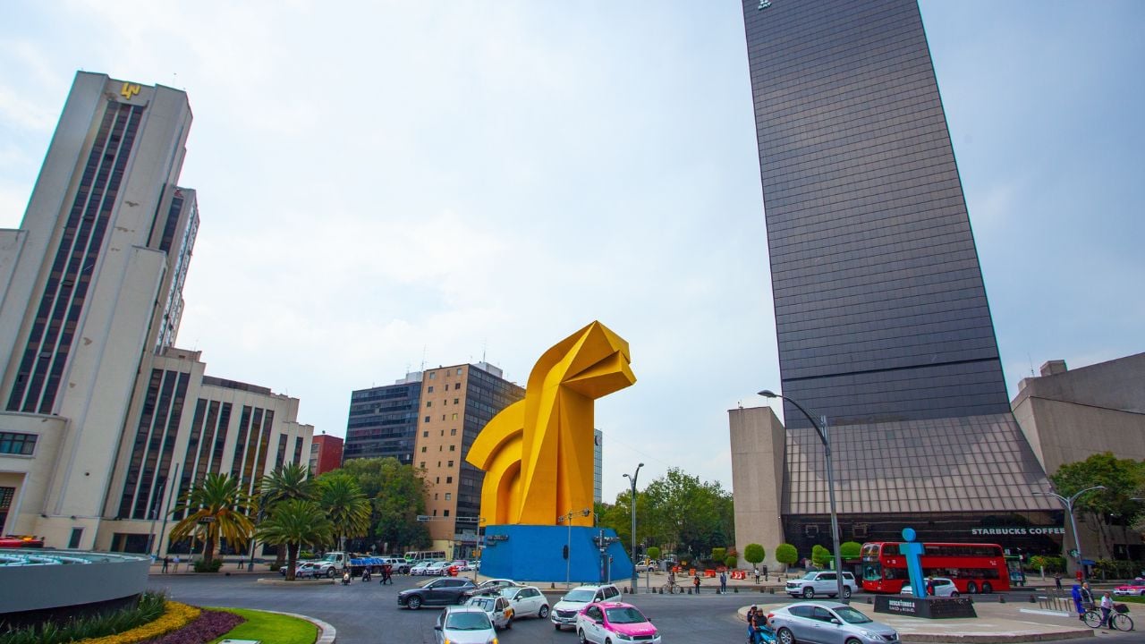 Mexico City, Mexico - April 15, 2022: Torre del Caballito skyscraper and Caballito sculpture (rocking horse) on Paseo de la Reforma, Mexico City.