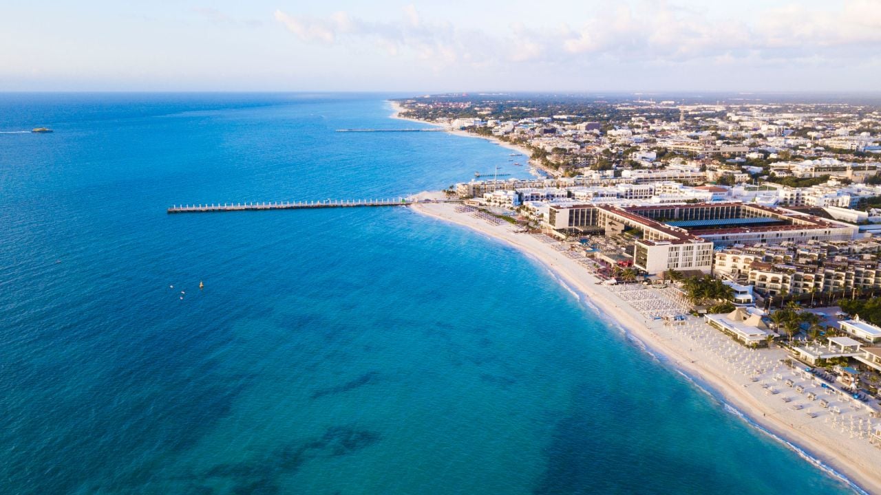 Aerial view of Playa Del Carmen, Mexico showing luxury resorts and blue turquoise beach during sunrise
