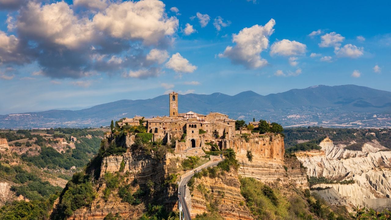 The famous Civita di Bagnoregio on a sunny day. Province of Viterbo, Lazio, Italy. Medieval town on the mountain, Civita di Bagnoregio, popular touristic stop at , Italy.