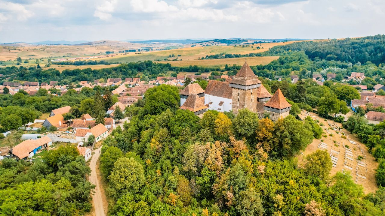 Viscri, Romania. Blue old painted traditional house from village, Transylvania. The Viscri fortified church