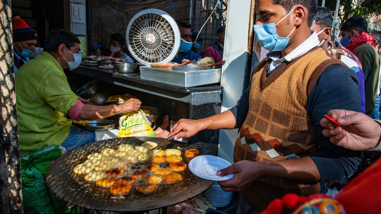 New Delhi, India-Jan 28 2022: A man frying aloo tikki at famous Natraj Dahi bhalla corner, Street food stall in chandni chowk Old Delhi