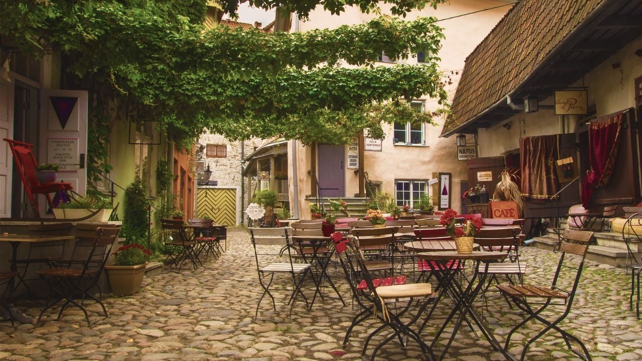 Old Tallinn, Estonia - 26 September 2019. Internal, festive and colorful courtyard of masters at the old town. Night mode. View from the inside.