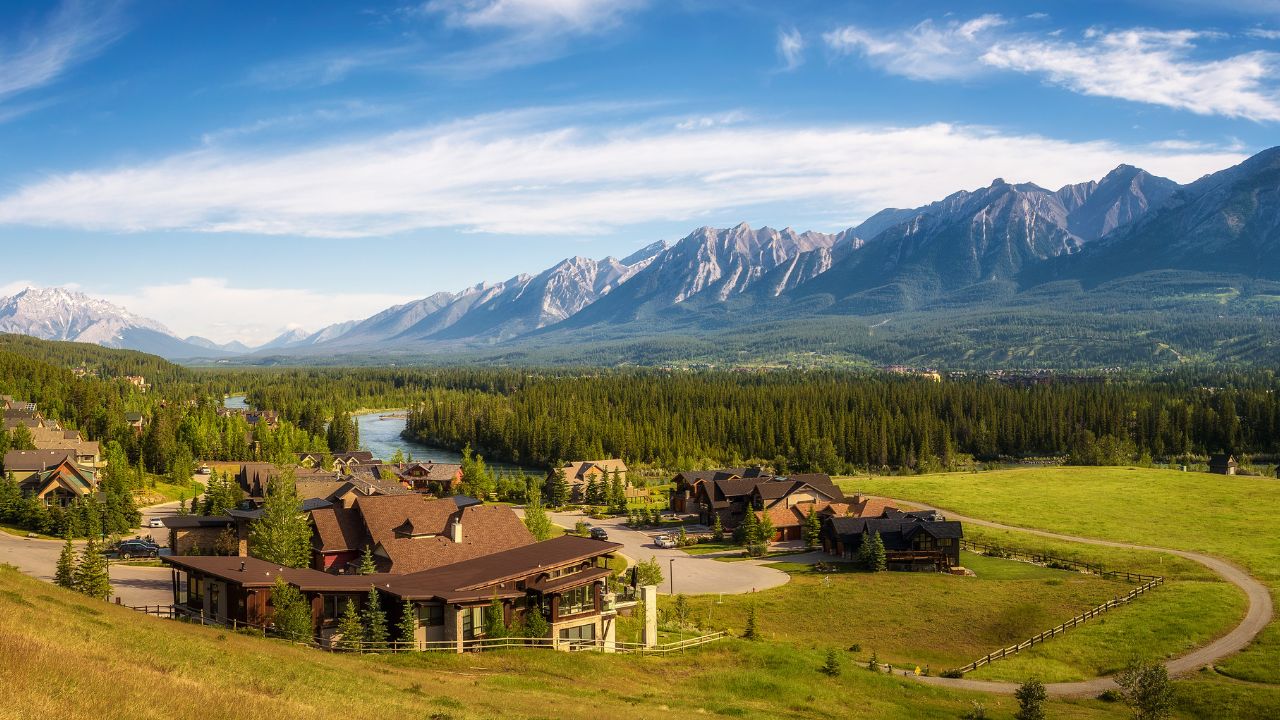 CANMORE, CANADA - JUNE 26, 2017 : Canmore in the Rocky Mountains with mountain peaks in background. Canmore is located in the Bow Valley near Banff National Park and is a popular tourist destination.