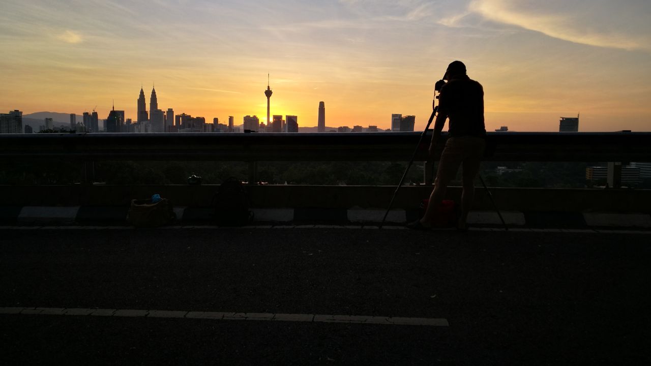 Silhouetted photographers during sunrise in Kuala Lumpur