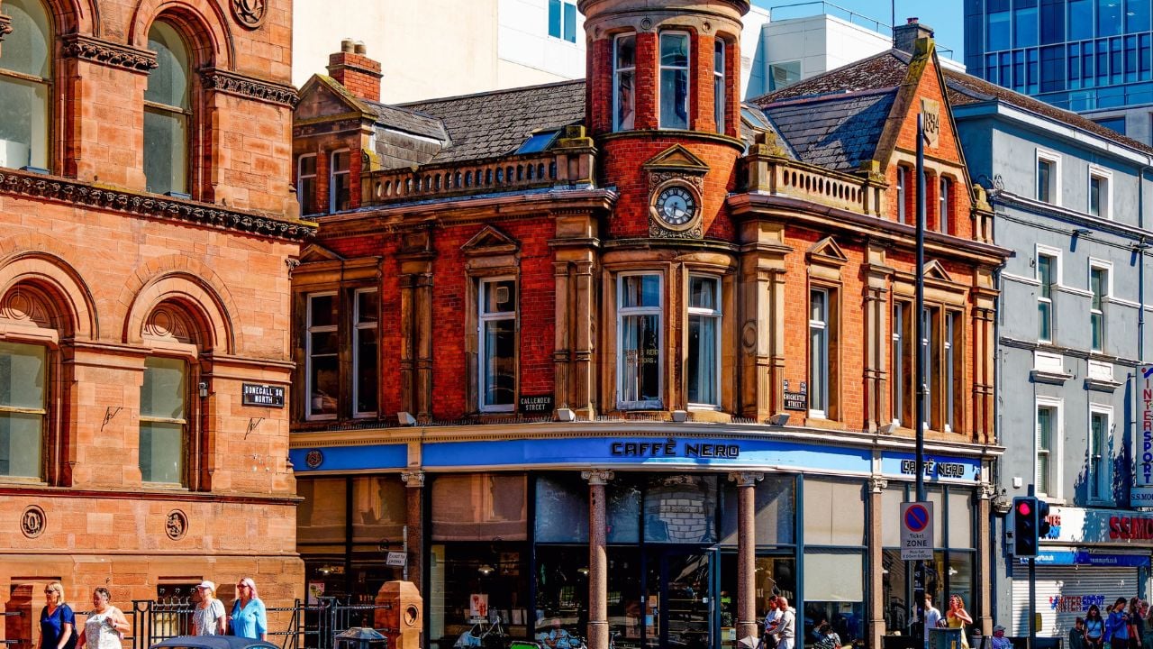 BELFAST, NORTHERN IRELAND - Aug 17, 2024: Caffè Nero occupies a prominent corner building in Belfast’s city center, blending Victorian design with a vibrant modern streetscape.