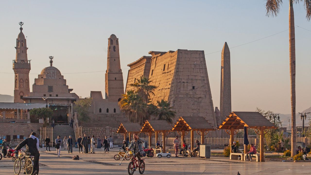 Luxor, Egypt - March 10, 2025: Locals enjoy a wonderful sunset evening in Luxor Temple Square. General view of Luxor Temple and Abou al-Haggag Mosqu