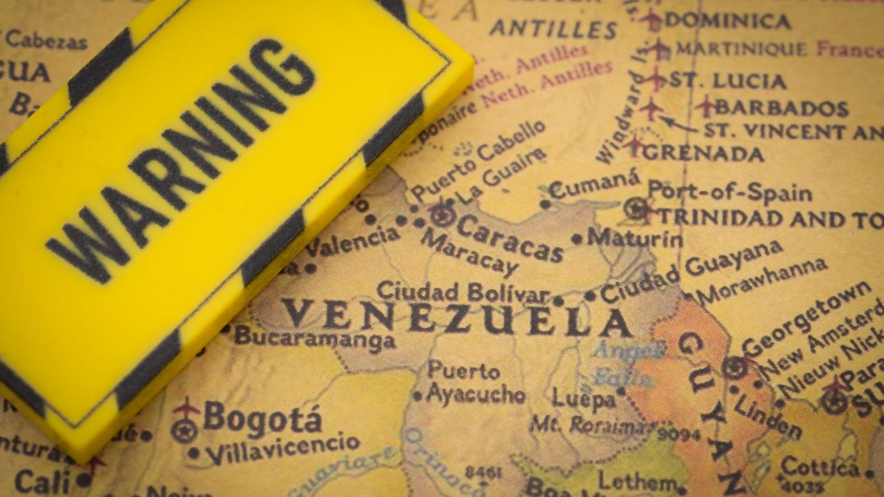 Warning sign on Venezuela map focusing on Caracas and coastal region, symbolizing alert or travel risk.