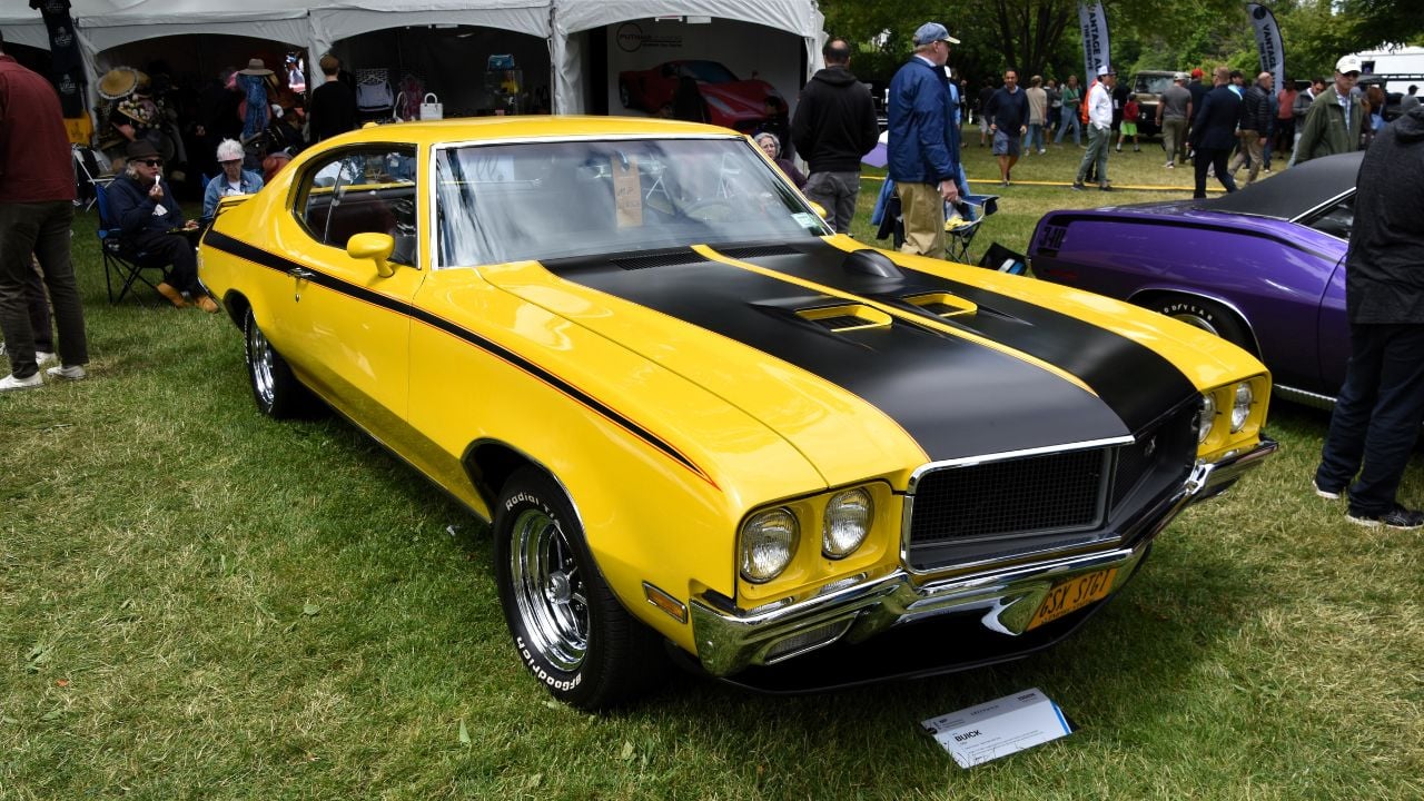 Saturn Yellow 1970 Buick GSX parked at a car show