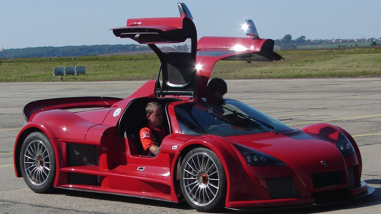 Maroon Gumpert Apollo front 3/4 with open gullwing doors