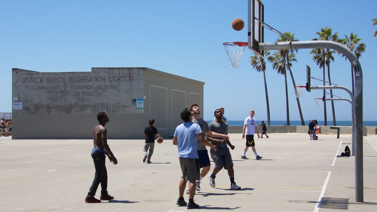 VENICE, CALIFORNIA - April 20, 2017: An group of unknown men playing basketball on an outdoor court in Venice Beach, California.