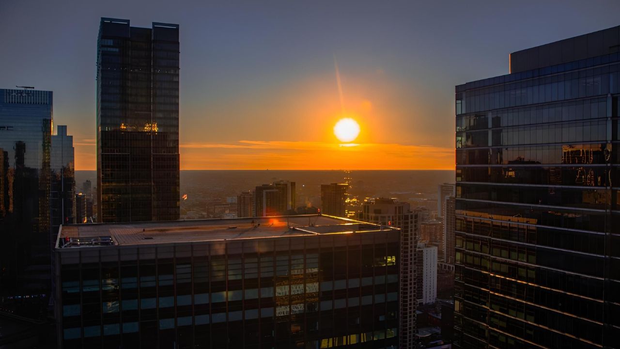 A stunning sunset view over a city skyline of Chicago with modern skyscrapers