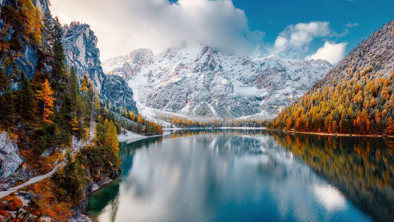 Great view of the mighty rock above peaceful alpine lake Braies (Pragser Wildsee). Location Dolomiti Alps, National park Fanes-Sennes-Braies, Italy, Europe. Photo wallpaper. The beauty of the Earth.