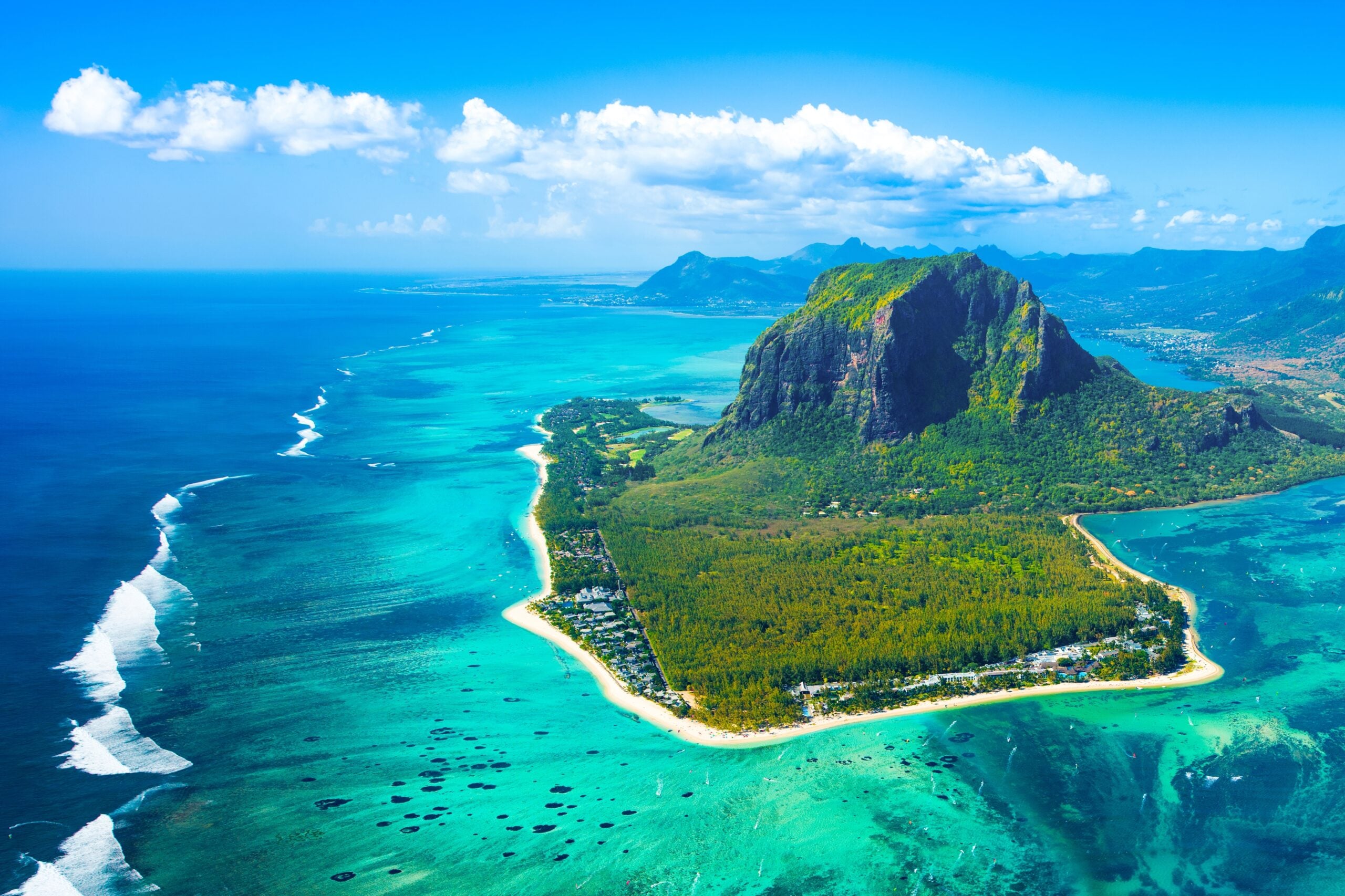 Aerial view of Mauritius island and Le Morne Brabant mountain with beautiful blue lagoon and underwater waterfall illusion
