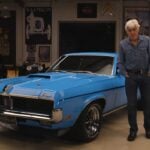 Front 3/4 shot of a Competition Blue 1969 Mercury Cougar Eliminator featured on Jay Leno's Garage with Jay Leno standing next to it