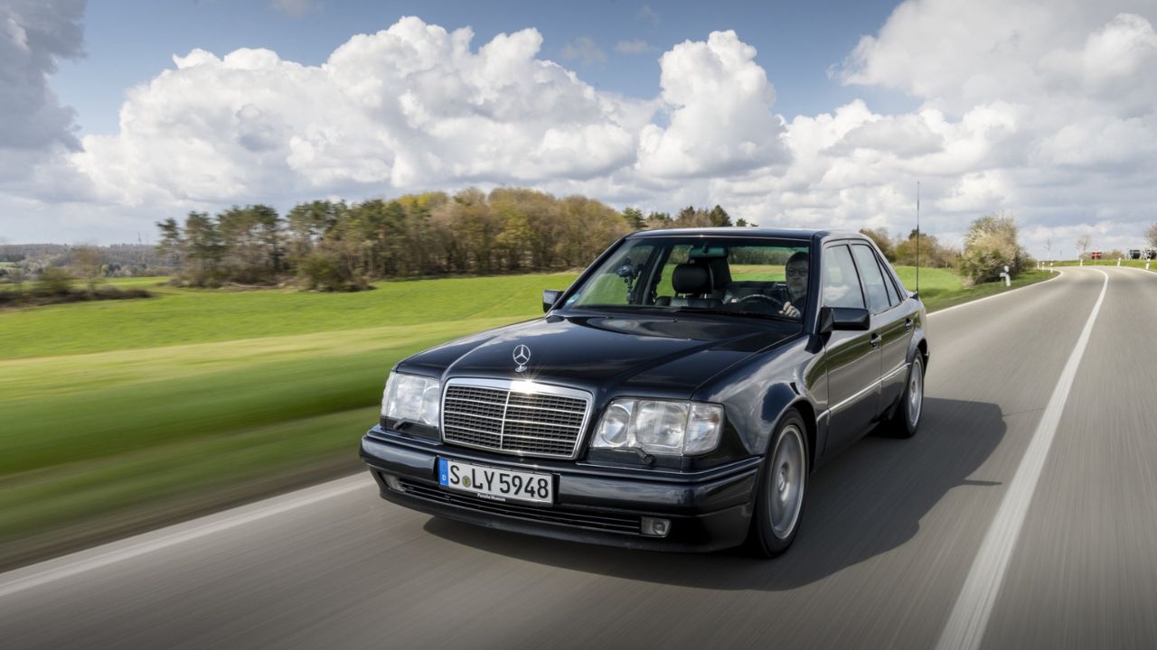 Front 3/4 shot of a Black Mercedes-Benz 500 E driving