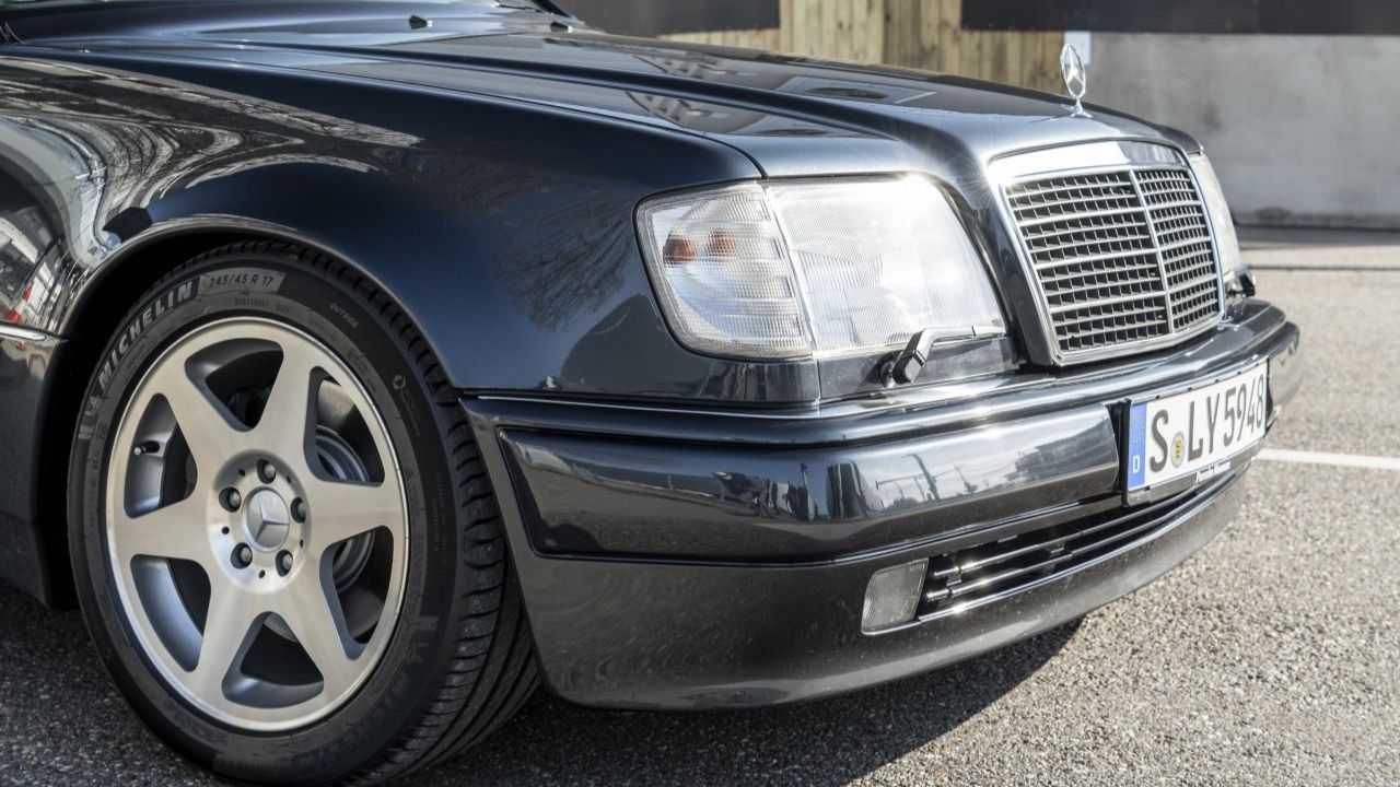 Headlight close-up shot of a Black Mercedes-Benz 500 E