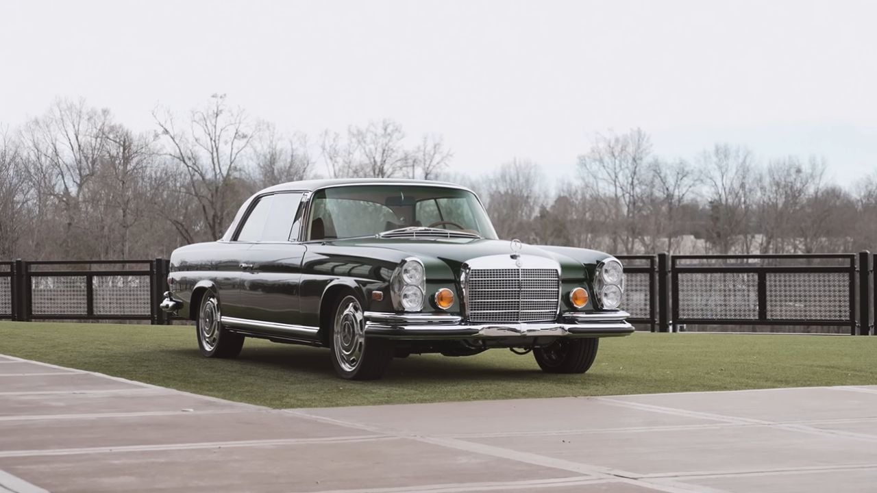Front 3/4 view of a parked 1969 Mercedes 280SE Restomod By Retro Designs