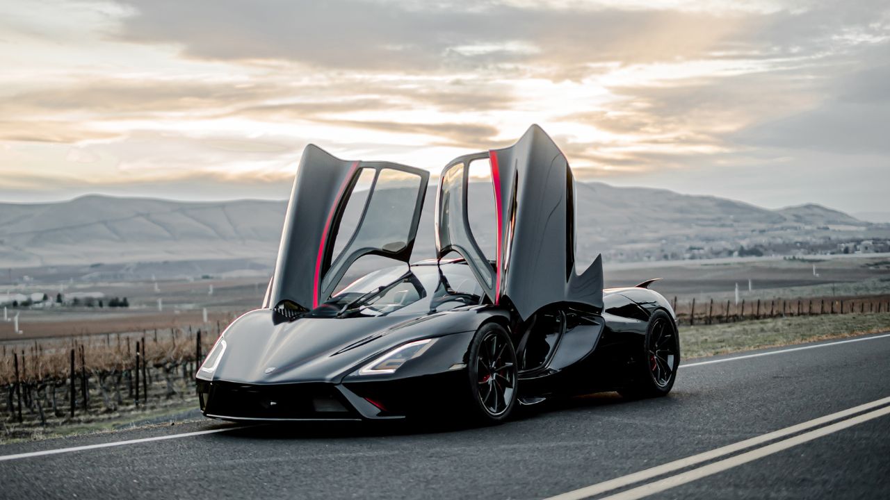 Front 3/4 shot of a Black SSC Tuatara parked with doors open