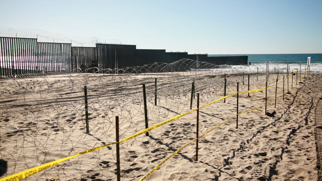 San Ysidro, California - 11/26/2018: Border fence between the USA and Mexico including New Construction adding an additional layer of fencing and razor wire or barbed wire to secure the border.