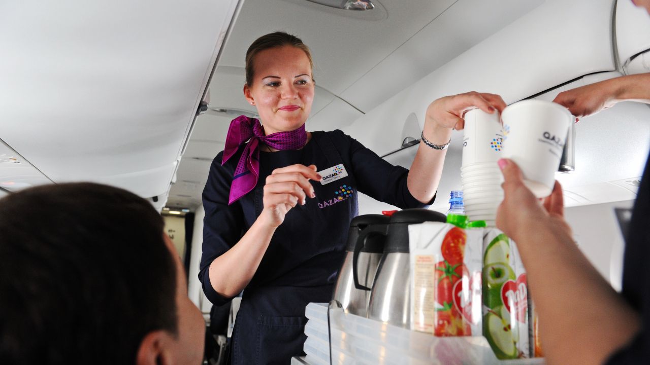 Almaty, Kazakhstan - 05.06.2016 : Flight attendants pour drinks for passengers