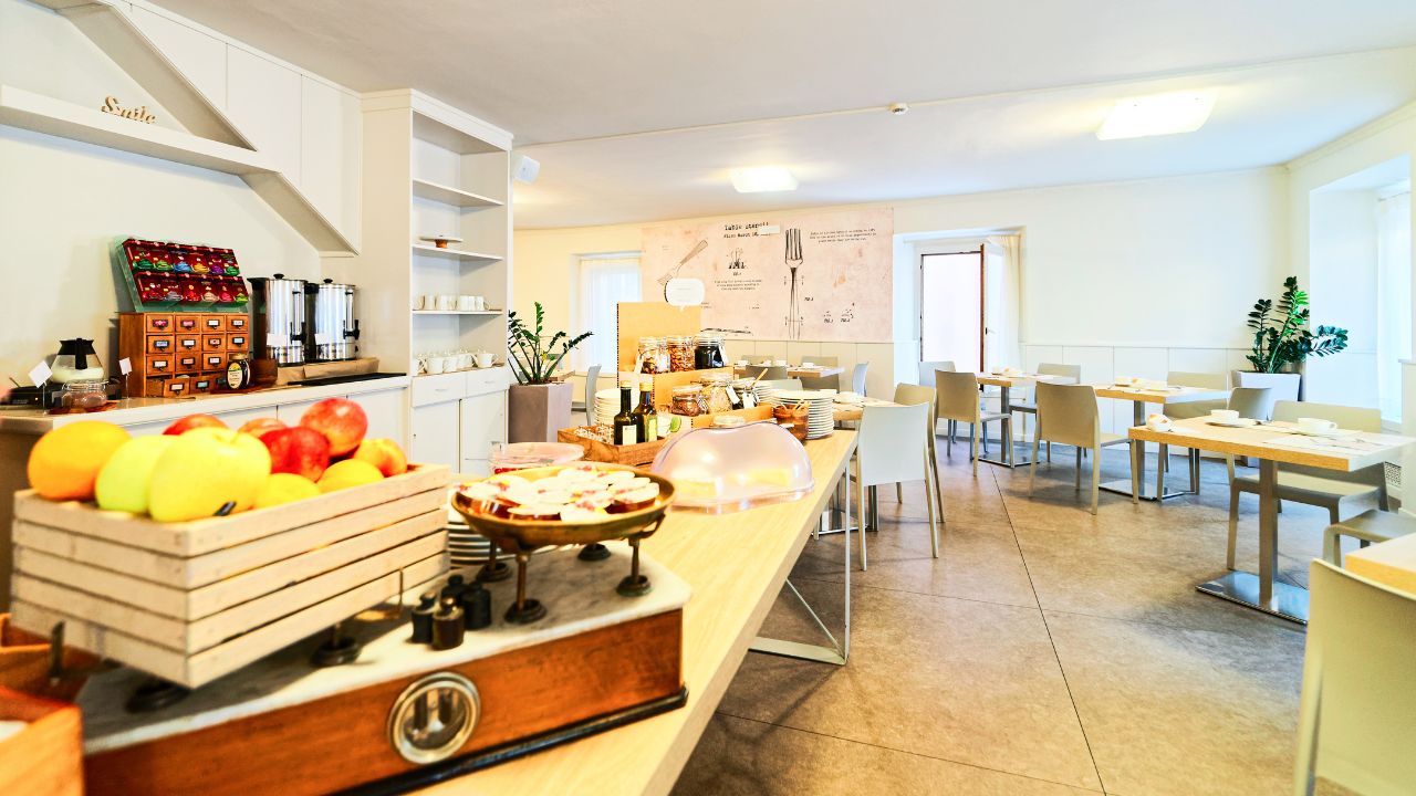 Hotel breakfast restaurant interior on background. Empty architecture white room with food and fruit. Bar table. Light Vintage style. Morning design. Cafe menu. Lunch, dinner snack. Modern lifestyle