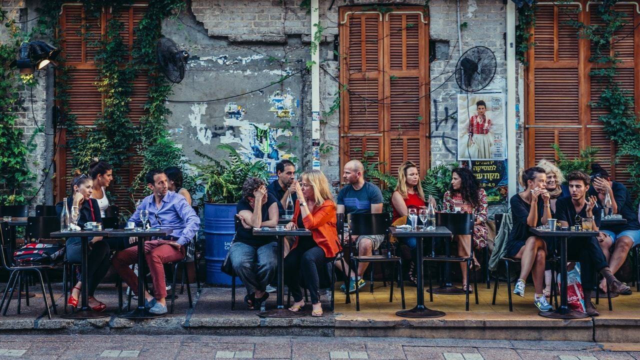 Tel Aviv, Israel - October 20, 2015. People sits at tables outside the restaurant at Rothschild Boulevard in Tel Aviv