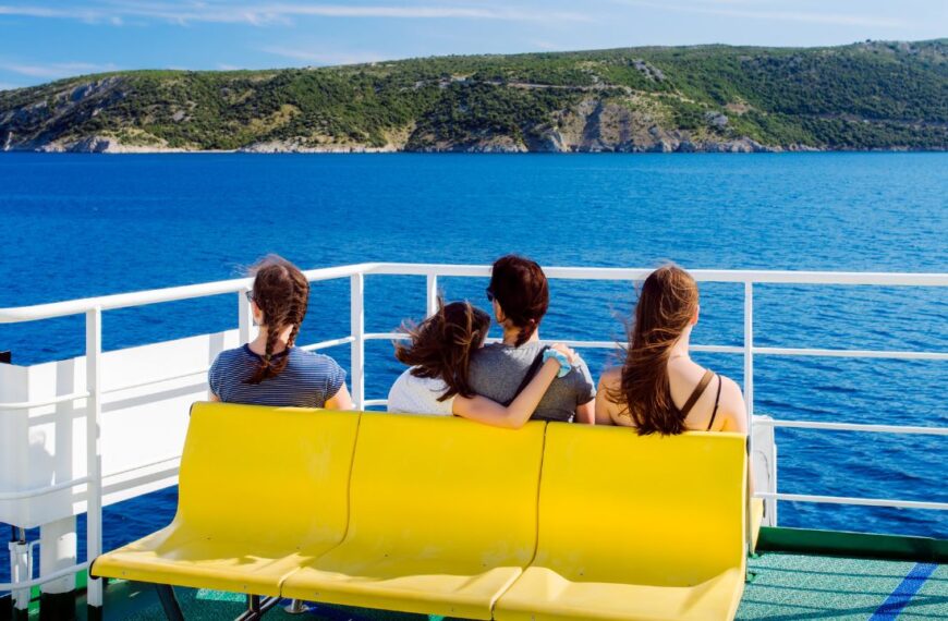 Family - mother with three daughters - on the ferry. The beginning of vacation - sea journey concept
