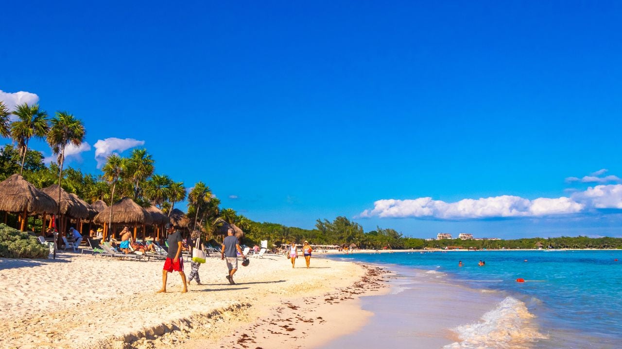 Playa del Carmen Quintana Roo Mexico 23. February 2024 Tropical mexican caribbean beach and sea with a lot of fun people sun loungers parasols turquoise palms water in Playa del Carmen Mexico.