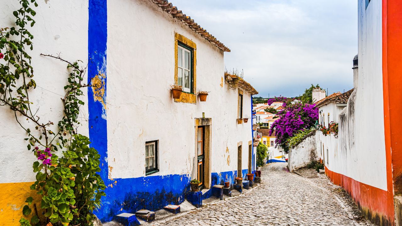 Narrow white-and-blue street in Óbidos, Portugal