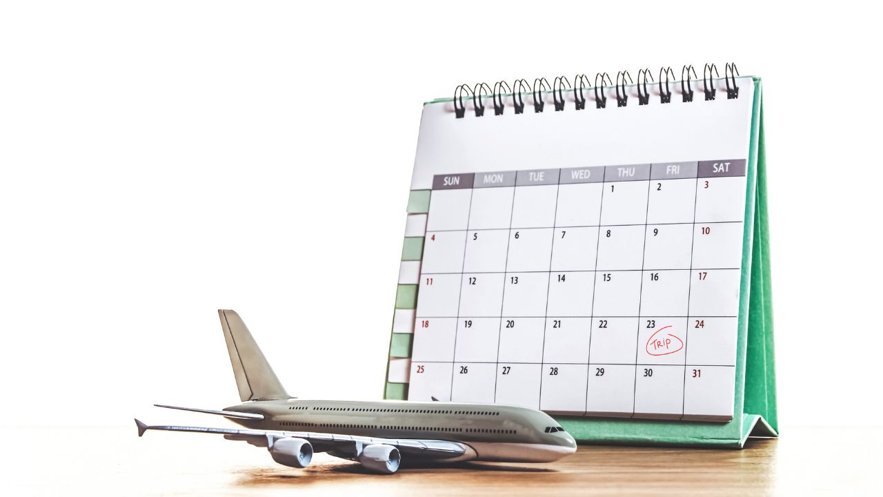 Travel planning scene with a calendar and airplane model