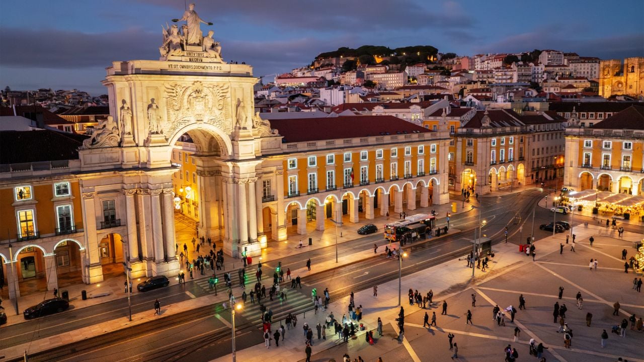 Praça do Comércio in Lisbon, Portugal, glowing with festive lights in the evening