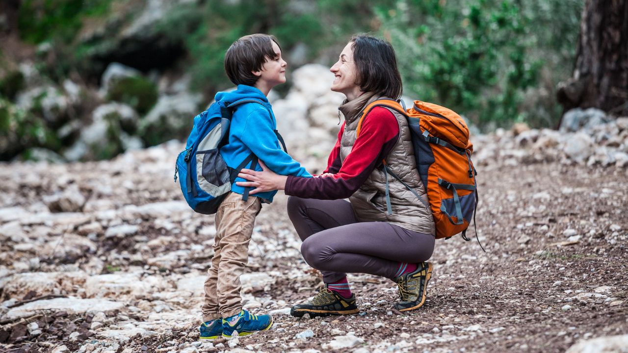 Woman hiking with her son in a forest