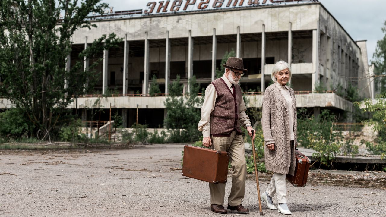 Travelers with suitcases near a building in Pripyat
