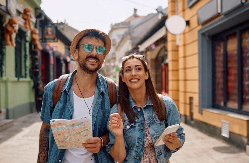 Happy tourist couple exploring the city during their journey. Copy space.