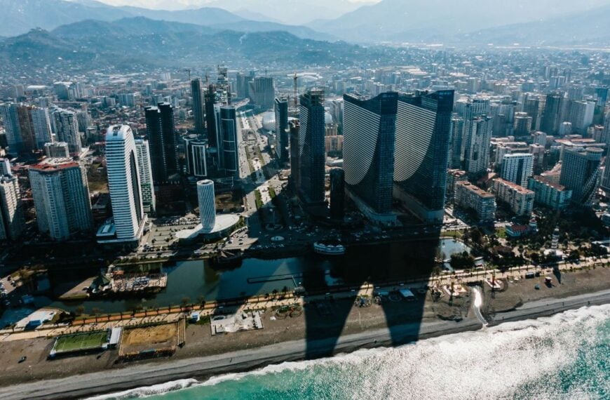 Aerial view of batumi city in georgia, showcasing modern skyscrapers, hotels, and residential buildings along the black sea coast, highlighting urban development and coastal tourism
