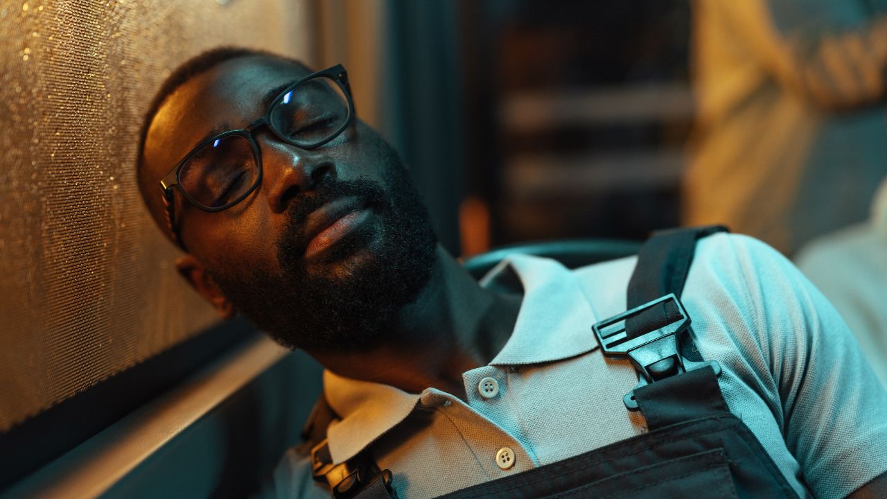 Passenger sleeping on a bus at night