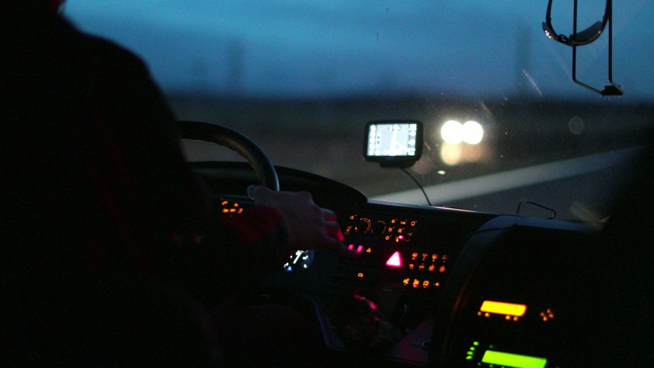 View from a bus driver’s seat on a road at night